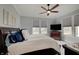 Relaxing bedroom with a ceiling fan, windows with blinds, and light grey walls at 1472 Windpump Way, Carmel, IN 46280