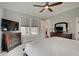 Comfortable bedroom with a ceiling fan, a TV, dresser, and windows that let in plenty of natural light at 1472 Windpump Way, Carmel, IN 46280