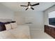 Bedroom featuring a dresser with TV, carpet, ceiling fan and plush pillows at 1472 Windpump Way, Carmel, IN 46280