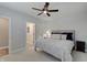 Comfortable bedroom with ceiling fan, carpet, and grey patterned comforter at 1472 Windpump Way, Carmel, IN 46280