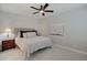 Cozy bedroom featuring a ceiling fan, and stylish bedside table with lamp at 1472 Windpump Way, Carmel, IN 46280