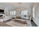 Bright dining room featuring a large wood table, bench seating, and sliding doors to the outdoor patio at 1472 Windpump Way, Carmel, IN 46280
