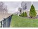 Home exterior featuring a manicured lawn, fence, and neatly arranged landscaping at 1472 Windpump Way, Carmel, IN 46280