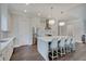 Light and airy kitchen with stainless steel appliances, and breakfast bar seating at the large kitchen island at 1472 Windpump Way, Carmel, IN 46280