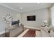 Home office with large desk, TV, and comfortable seating area at 1472 Windpump Way, Carmel, IN 46280