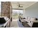 Covered patio with a grill, ceiling fan, comfortable seating, and neighborhood views at 1472 Windpump Way, Carmel, IN 46280