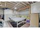 Spacious unfinished basement features exposed beams, table tennis and ample room for customization, ideal for storage or recreation at 1472 Windpump Way, Carmel, IN 46280