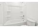 Bathroom featuring a shower-tub combo and tiled walls and floors at 1554 N Clearwater Dr, Greenfield, IN 46140