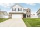 Charming two-story home featuring a brick facade and a spacious two-car garage at 1554 N Clearwater Dr, Greenfield, IN 46140