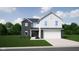 New two-story home featuring black and white siding, attached two-car garage, and professional landscaping at 1554 N Clearwater Dr, Greenfield, IN 46140