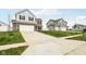 Suburban homes on a street with a manicured lawn and long driveways at 1554 N Clearwater Dr, Greenfield, IN 46140