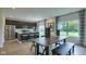Open-concept kitchen featuring stainless appliances, light countertops, island with seating and an adjacent dining area at 1554 N Clearwater Dr, Greenfield, IN 46140