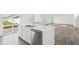 Bright white kitchen featuring a kitchen island, stainless steel appliances, and hardwood floors at 1554 N Clearwater Dr, Greenfield, IN 46140