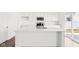 Bright white kitchen island and stainless steel appliances with hardwood floors at 1554 N Clearwater Dr, Greenfield, IN 46140
