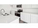 Bright white kitchen featuring stainless steel appliances, and hardwood floors at 1554 N Clearwater Dr, Greenfield, IN 46140