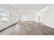 Bright, open living room with light wood flooring, recessed lighting, and multiple windows at 1554 N Clearwater Dr, Greenfield, IN 46140