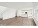 Bright open-concept room featuring hardwood floors and stairs at 1554 N Clearwater Dr, Greenfield, IN 46140