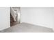 Open-concept living room featuring neutral carpet, white walls, and staircase access at 1554 N Clearwater Dr, Greenfield, IN 46140