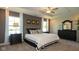 Spacious bedroom features carpet flooring, neutral walls, tray ceiling with fan, large windows and stylish furnishings at 1554 N Clearwater Dr, Greenfield, IN 46140
