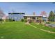 Spacious backyard featuring a blue house, wooden deck, and lush green grass at 16471 E 196Th St, Noblesville, IN 46060