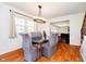 Formal dining room with a glass-top table, upholstered chairs, and modern chandelier at 16471 E 196Th St, Noblesville, IN 46060