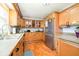 Traditional kitchen boasts stainless steel refrigerator, light wood cabinets, and laminate flooring at 16471 E 196Th St, Noblesville, IN 46060