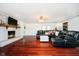 Bright and airy living room with a brick fireplace, hardwood floors, and leather furniture at 16471 E 196Th St, Noblesville, IN 46060