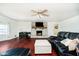 Comfortable living room with hardwood floors, brick fireplace, and a ceiling fan at 16471 E 196Th St, Noblesville, IN 46060