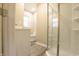 Bright bathroom featuring a glass shower, white vanity, and gray wood-look flooring at 1760 Market St, Martinsville, IN 46151