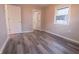 Neutral bedroom features a closet, an entrance to the bathroom, wood-look flooring, and a window at 1760 Market St, Martinsville, IN 46151