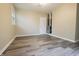 Empty room with gray wood-look flooring, white trim, and a ceiling fan at 1760 Market St, Martinsville, IN 46151