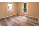 Bedroom featuring two windows, wood-look flooring, and neutral walls at 1760 Market St, Martinsville, IN 46151