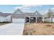 Beautiful brick home boasting a covered porch and well-lit driveway, perfect for a welcoming entrance at 19245 Red Willow Ln, Noblesville, IN 46062