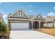 Charming brick home featuring a two-car garage and covered porch, set under a bright blue sky at 19245 Red Willow Ln, Noblesville, IN 46062