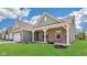 Beautiful home with a covered porch, brick facade, and well-maintained green lawn at 19245 Red Willow Ln, Noblesville, IN 46062