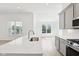 Bright kitchen with white countertops, stainless steel appliances, and a view from the windows at 19245 Red Willow Ln, Noblesville, IN 46062