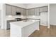 Modern kitchen with gray cabinetry, stainless steel appliances, a white subway tile backsplash and hardwood floors at 19245 Red Willow Ln, Noblesville, IN 46062