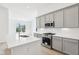 Modern kitchen with gray cabinets, stainless steel appliances, and a stylish white countertops and white subway tile backsplash at 19245 Red Willow Ln, Noblesville, IN 46062