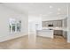 Spacious living area and kitchen featuring hardwood flooring, abundant natural light, and an open layout at 19245 Red Willow Ln, Noblesville, IN 46062