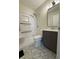 A full bathroom including a shower, toilet, vanity, hexagon tile flooring, and modern lighting at 2050 Winton Ave, Indianapolis, IN 46224