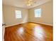 A spacious bedroom with hardwood flooring and two windows at 2050 Winton Ave, Indianapolis, IN 46224