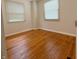 A bedroom featuring hardwood floors, two windows, and blinds at 2050 Winton Ave, Indianapolis, IN 46224