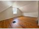 Cozy bedroom featuring wood floor, neutral paint, and natural light from a window at 2050 Winton Ave, Indianapolis, IN 46224