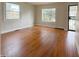 Bright living room with gleaming hardwood floors, large windows, and views of the front yard at 2050 Winton Ave, Indianapolis, IN 46224