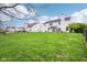 Large backyard with a well-maintained lawn and a view of neighboring houses at 2236 Willowview Dr, Indianapolis, IN 46239