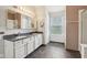 Bathroom featuring double sinks, white cabinets, and a window with natural light at 2236 Willowview Dr, Indianapolis, IN 46239