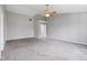 Spacious bedroom with neutral carpet, ceiling fan, and access to the bathroom at 2236 Willowview Dr, Indianapolis, IN 46239