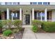 Inviting front porch with classic white columns, hanging flower baskets, and manicured landscaping at 2236 Willowview Dr, Indianapolis, IN 46239