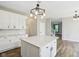Bright kitchen with white cabinets, quartz countertops, and a view to the dining and living areas at 2236 Willowview Dr, Indianapolis, IN 46239