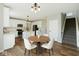 Modern kitchen with stainless steel appliances, white cabinets, and a breakfast nook next to the staircase at 2236 Willowview Dr, Indianapolis, IN 46239